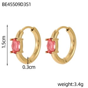 Detail of small gold hoop earrings featuring pink oval stones and sleek polished finish