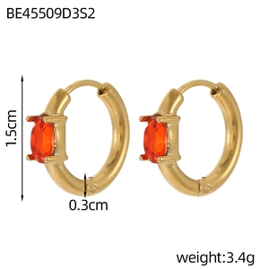 Detail view of 1.5cm gold hoop earrings featuring oval orange-red gemstones