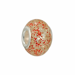 Macro detail of a translucent cream resin charm bead with vibrant red glitter and silver core