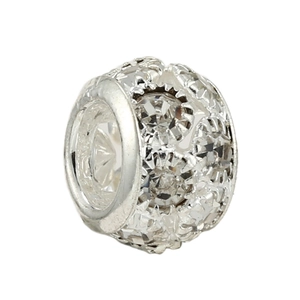 Macro detail of silver charm bead featuring hollow star patterns and pavé crystals