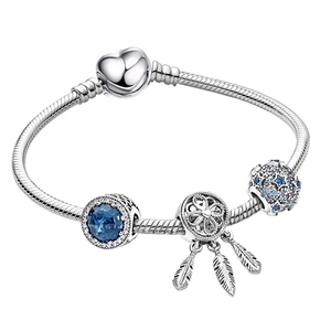 Silver charm bracelet with blue stone pendant, dreamcatcher charm, and heart clasp