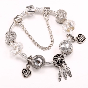 Silver-plated snake chain bracelet featuring heart charms and dreamcatcher pendant detail