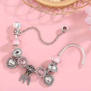 Pink dreamcatcher charm bracelet with silver snake chain and heart-shaped pendant