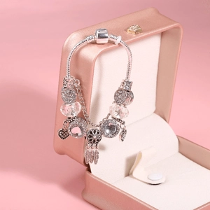 Pink dreamcatcher charm bracelet with silver snake chain in a premium jewelry gift box