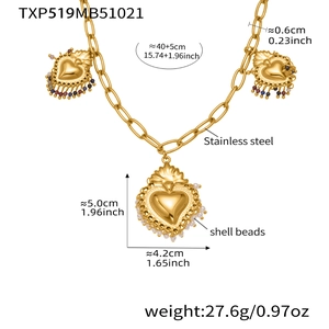 Detailed view of golden stainless steel necklace with sacred heart pendants and shell beads