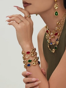 Detailed close-up of 18k gold plated hollow pig-nose link jewelry set with colorful glass stones