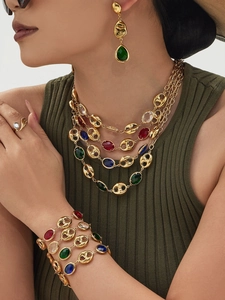 Detail view of 18k gold plated hollow nose chain jewelry set with colorful glass stones