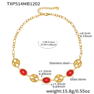 Macro view of 18k gold plated stainless steel necklace with red glass stone detail