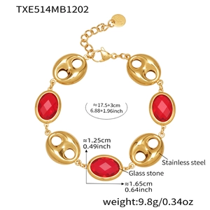 Detail of gold stainless steel link bracelet with red oval stones and lobster clasp