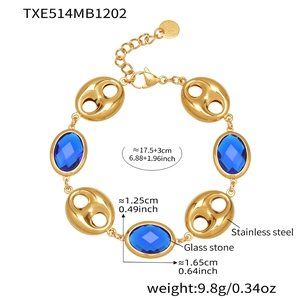 Macro detail of 18k gold plated stainless steel bracelet with blue glass stone and pig nose links