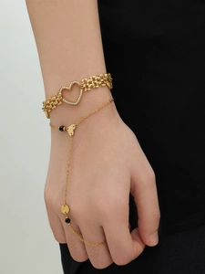 Detail of 18k gold plated stainless steel heart chain and zircon ring bracelet