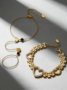 Detail of 18k gold plated heart charm bracelets with zircons and lobster clasp closure