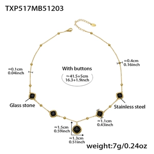 Detailed view of gold stainless steel necklace with five black geometric glass stones