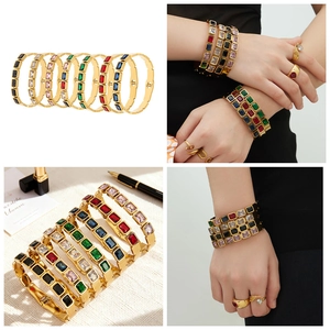 Close-up of 18k gold plated bangle featuring colorful square-cut gemstone inlays