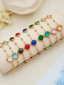 Detail of square glass stone bracelets in multiple colors with gold stainless steel beads