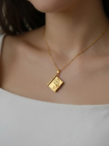 Detail of 18k gold plated book pendant with My Little Star engraving on a dainty chain