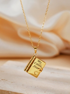 Macro detail of 18k gold plated book pendant necklace with My Little Star engraving