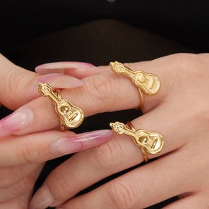 Three-piece gold guitar rings set in polished stainless steel for music lovers