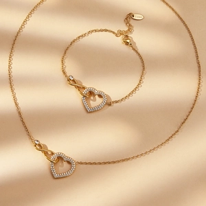 Parure collier et bracelet en acier inoxydable doré avec cœur et symbole infini scintillant