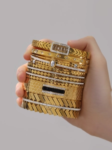 Detailed close-up of 18k gold-plated stackable bracelets with zircon inlay and marble stone