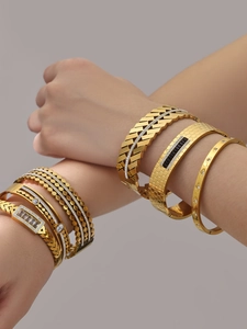 Stacked 18k gold plated stainless steel bangles with geometric zircon inlay details