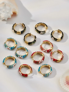 Detail of colorful enamel hoop earrings with floral print on 18k gold plated stainless steel
