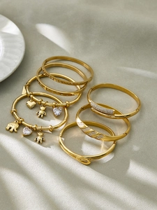 Detailed collection of 18k gold plated stainless steel bangles with 5A zircon charms