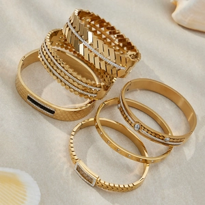 Stack of 18k gold plated stainless steel geometric bangles with zircon inlay details