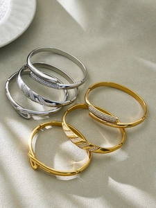 Detailed collection of 18k gold and silver plated bangles with CZ geometric pave patterns