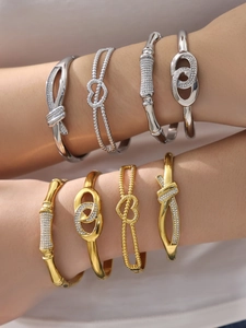 Detail of 18k gold plated stainless steel bracelets with zirconia infinity heart charms