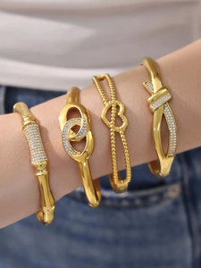 Detail of four-piece 18k gold plated bracelet set with zircon accents on model wrist