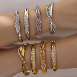 Stack of gold and silver plated stainless steel bracelets with pavé cubic zirconia accents