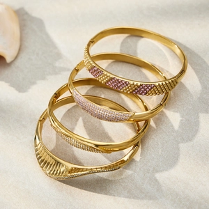 Stack of gold-plated stainless steel bangles with zircons and checkered patterns
