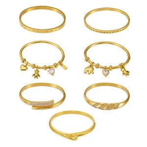 Set of seven 18k gold plated stainless steel bracelets featuring 5A zircon and charms