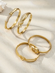Macro shot of 18k gold plated bracelets set with infinity heart and zircon details