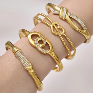 Set of four gold-plated stainless steel bracelets with zircon infinity and heart designs