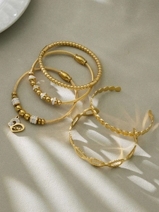 Detailed set of five 18k gold plated stainless steel bangles with love heart charm and zircons