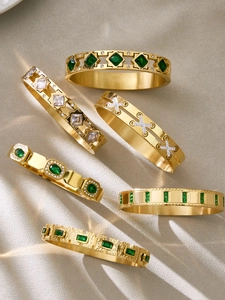 Close-up of 18k gold plated stainless steel bangles with green and clear zircon stones