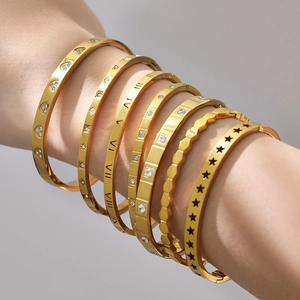 Set of seven gold plated stainless steel bangles with Roman numerals and zircon stones