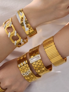 Close-up of gold-plated honeycomb bangles with sparkling zircon and mother of pearl detail