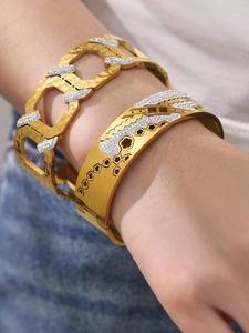 Detail of 18k gold plated honeycomb wide cuff bracelet set with zircon stones on wrist