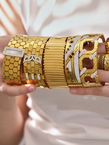 Detail of 18k gold plated stainless steel bangles with honeycomb and zircon inlay