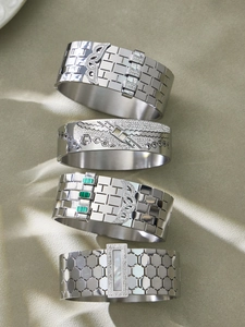 Macro detail of honeycomb textured silver bangles with malachite and zircon inlays