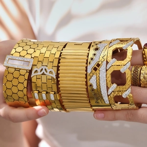 Golden honeycomb cuff bracelet with zircon insets and chunky luxury jewelry stack