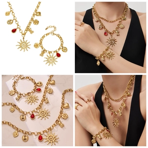 Details of vintage gold bohemian necklace and bracelet set with sun and bear charms