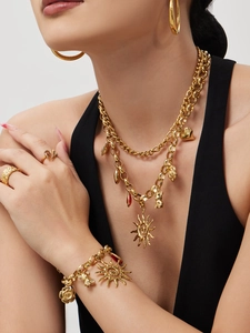 Golden sun and bear pendant necklace set shown on model with jewelry accessories
