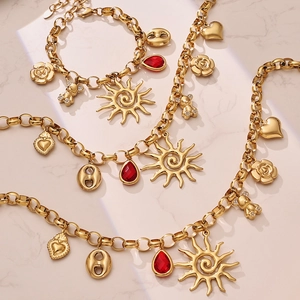 Golden stainless steel sun and bear multi-pendant necklaces on marble surface