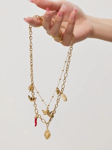 Detailed layered 18k gold-plated necklaces featuring heart, angel, and red horn charms