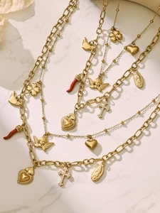 Detail of 18k gold plated double layer necklace with religious and fashion charms