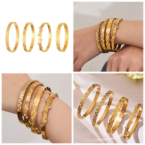 Detail of four 18k gold plated stainless steel bangles with teardrop and floral zircon designs